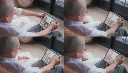 亚洲年迈的祖父母感觉爱和快乐，通过视频电话在家里庆祝虚拟生日，在社交距离，由他们的家人和侄女准备蛋糕。新标准的概念。高清在线视频素材下载