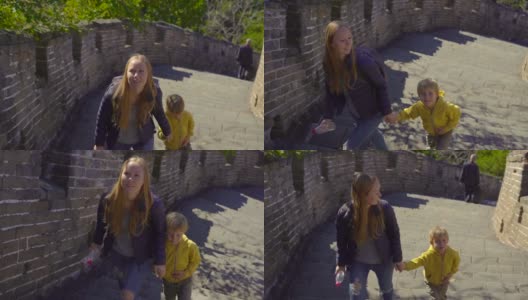 斯坦尼康镜头拍摄了一个年轻的女人和她的小儿子走上中国长城的楼梯高清在线视频素材下载