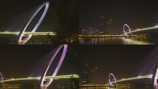 夜光时分，照亮了南京市内著名的现代化人行天桥，江滨公园全景4k中国高清在线视频素材下载