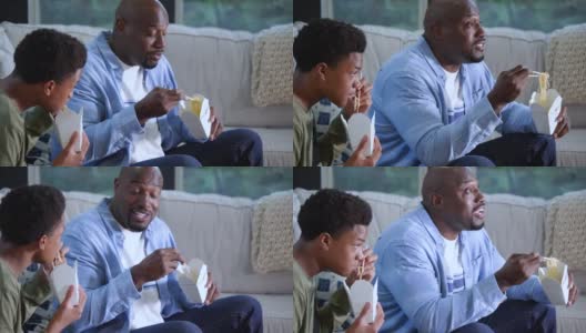 非裔美国父亲，儿子看电视吃外卖高清在线视频素材下载