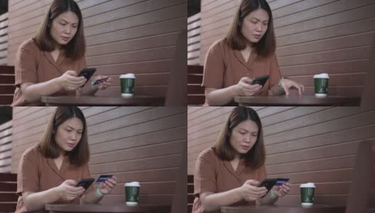 一位女士在咖啡厅用信用卡网上购物高清在线视频素材下载