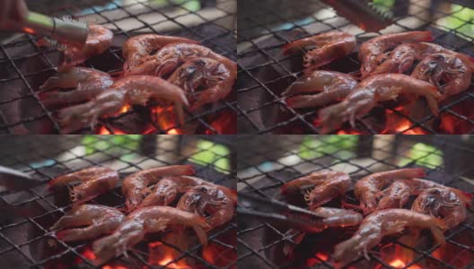 用传统的炉子烤虾。泰国海鲜菜单，味道鲜美。泰国街头小吃菜单。燃烧着木炭，下面有炽热的火焰。热菜单，适合野餐时间。高清在线视频素材下载