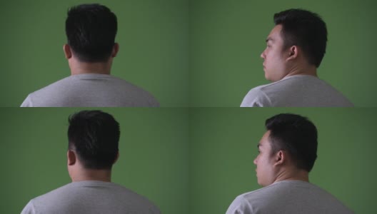 年轻英俊的超重亚洲男子对绿色背景高清在线视频素材下载