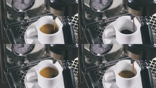 浓缩咖啡从经典的咖啡机倒入小的白色杯子。高清在线视频素材下载