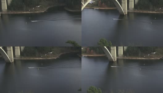 一艘摩托艇从混凝土桥下驶过。河上的混凝土桥。高清在线视频素材下载