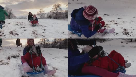 圣诞假期，姐妹们在雪山上共用一辆雪橇高清在线视频素材下载