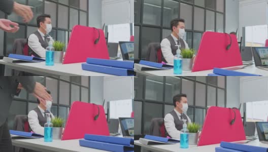 亚洲团队的商务人士在办公室工作与新的正常的社会距离的生活理念。商户应佩戴防护口罩，使用洗手液，以预防新冠病毒感染高清在线视频素材下载