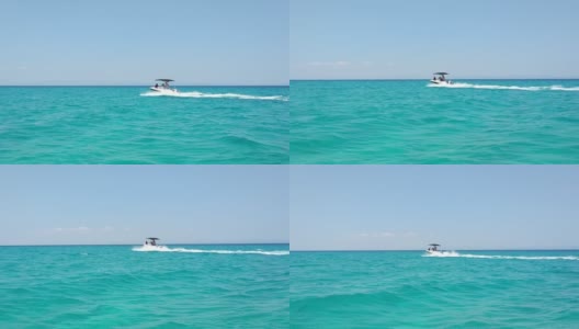 在希腊的哈尔基迪基地区，快艇在夏天的海面上行驶，蔚蓝的天空，蔚蓝的大海，高清在线视频素材下载
