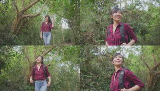 一个年轻的亚洲女人独自在森林里旅行。女孩在大自然中感受着清新、美妙、刺激和放松，环顾四周的风景，然后继续快乐地散步。高清在线视频素材下载