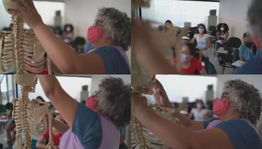 老师在课堂上教人体解剖学，戴着骷髅面具高清在线视频素材下载