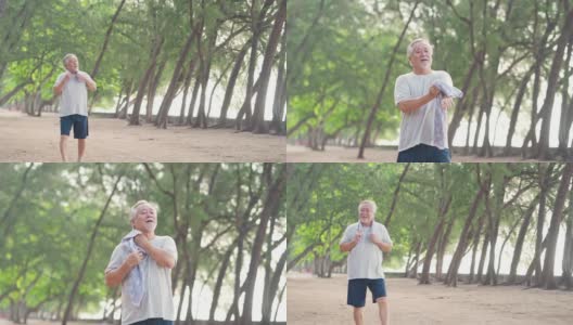 4K快乐的亚洲老人早上在海滩上锻炼。高清在线视频素材下载