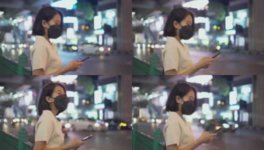 亚洲女性在等出租车时使用智能手机高清在线视频素材下载