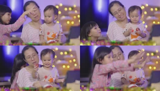 亚洲家庭单亲母亲和两个女儿坐在客厅的晚上，电话会议与祖父母一起庆祝新年派对高清在线视频素材下载