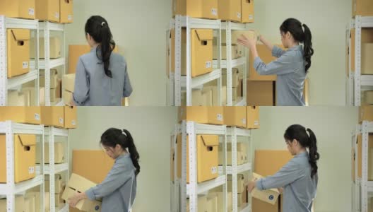 亚洲女工在仓库分拣箱子到仓库货架，储存和分配的概念。高清在线视频素材下载