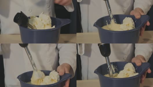 糕点师将搅拌器连接起来，并开始在碗中搅拌奶油蛋羹。厨师为蛋糕做奶油蛋羹高清在线视频素材下载