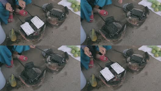 传统烹饪热华夫饼使用老式华夫饼铁在木炭上高清在线视频素材下载