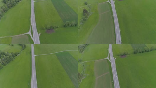 飞过高速公路，汽车穿过绿色的草地高清在线视频素材下载