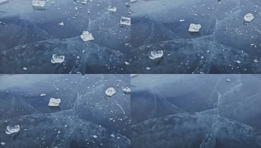 戴手套的人在冰上打碎冰。缓慢的运动。镜头移到了冰的后面。一块美丽的冰在冰的周围裂开，有神奇的裂缝。冰冻水的颗粒。高清在线视频素材下载