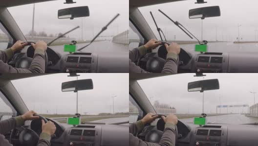 智能手机与绿色空白屏幕在汽车上的方向，按摩，位置。现代汽车和智能手机的绿屏司机。色度键。男人在阴雨天开车。下雨了。业务。高清在线视频素材下载