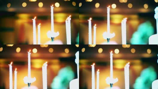 手持相机:婚礼上的蜡烛和金色的焦景背景。高清在线视频素材下载