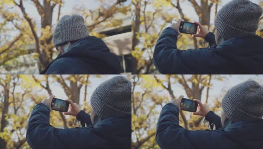 潮男用智能手机拍银杏树高清在线视频素材下载