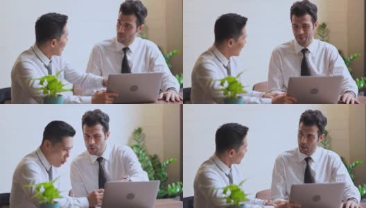 商人和合作伙伴一起讨论在笔记本电脑上的业务表现高清在线视频素材下载
