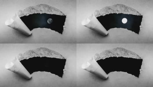 创造性的4k时间循环播放了一个在夜空中发光的满月和漂浮的云的视频，这是通过一个带有撕裂边缘的旧复古旧纸洞可以看到的。高清在线视频素材下载