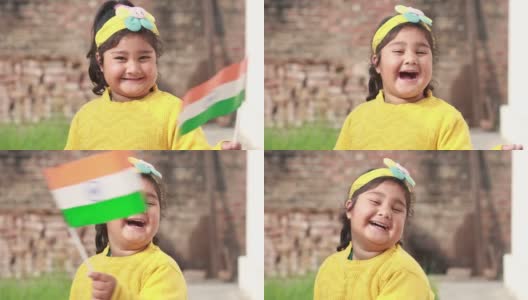 快乐的印度小女孩骄傲地挥舞着印度三色旗。高清在线视频素材下载