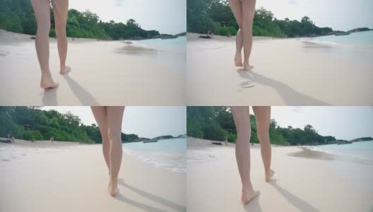 女腿漫步在海岛碧蓝的海水沙滩，浪花飞溅的海浪，热带夏日度假，旅游目的地，跟随女腿漫步在阳光明媚的海岛天堂，享受夏日假期高清在线视频素材下载