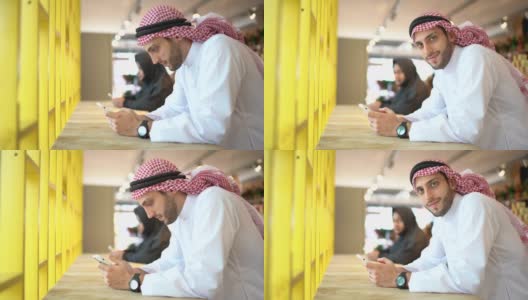 阿拉伯中东男子在便利店使用手机的肖像高清在线视频素材下载