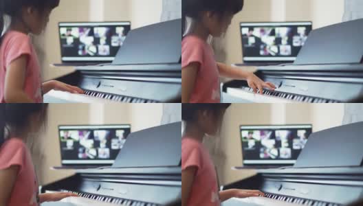 亚洲小女孩在家里学习在线钢琴课。高清在线视频素材下载