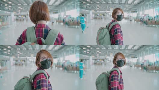 在新冠肺炎期间，亚洲女性游客佩戴防护口罩在机场保护冠状病毒高清在线视频素材下载