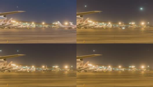 间隔拍摄。北京首都国际机场夜间航站楼，飞机起降。高清在线视频素材下载