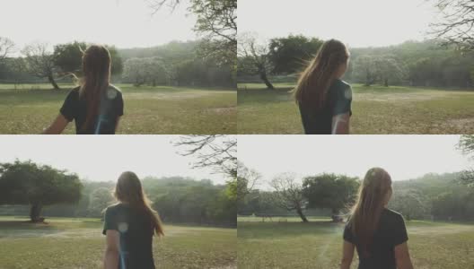 日落时分在公园里散步的女人高清在线视频素材下载