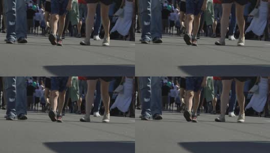 许多人双腿走在宽阔的城市街道上，城市喜庆，慢镜头高清在线视频素材下载