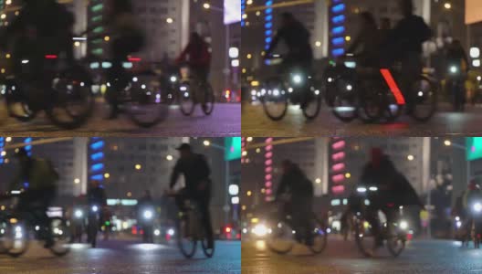很多骑自行车的人在晚上骑自行车，自行车游行在模糊的灯光城市街道时间推移。一群骑自行车的人。自行车交通。概念运动健康的生活方式。明亮的强光照射。低角度的观点高清在线视频素材下载