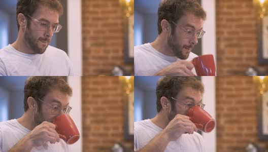 有魅力的男人在早上喝咖啡，然后吞咽高清在线视频素材下载