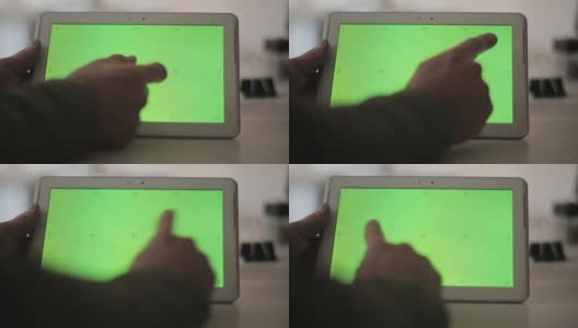 手持空白平板电脑的男子对着绿色屏幕。高清在线视频素材下载