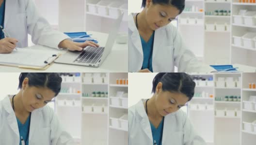 中年亚洲女性药剂师在药店工作时使用笔记本电脑高清在线视频素材下载