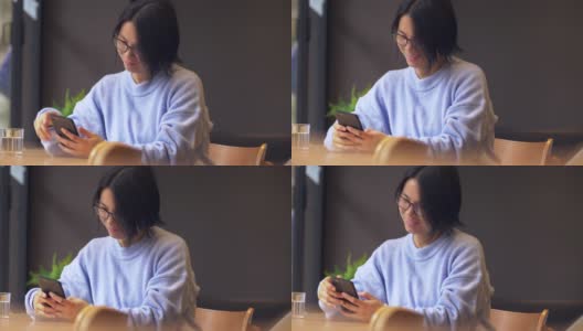一位年轻的中国女子正在玩手机高清在线视频素材下载