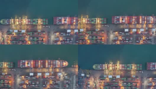 集装箱船夜间作业，远洋集装箱船经营国际进出口物流运输，鸟瞰图。高清在线视频素材下载
