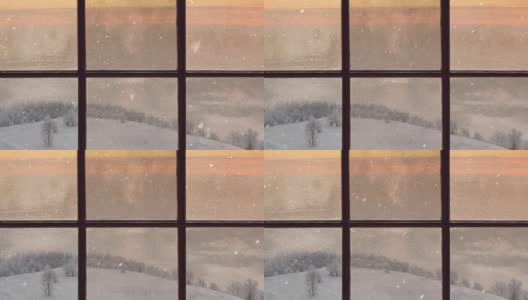 一扇木窗的剪影俯瞰着冬天的黄昏森林。美丽的冬季景观与飘落的雪高清在线视频素材下载