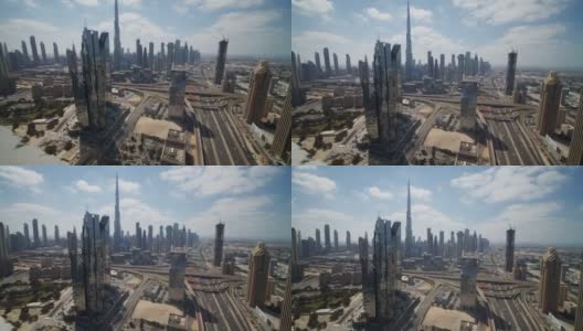 阳光明媚的一天，迪拜市中心高耸的摩天大楼和高速公路交通。迪拜市中心有现代化的摩天大楼和哈利法塔旅游景点高清在线视频素材下载