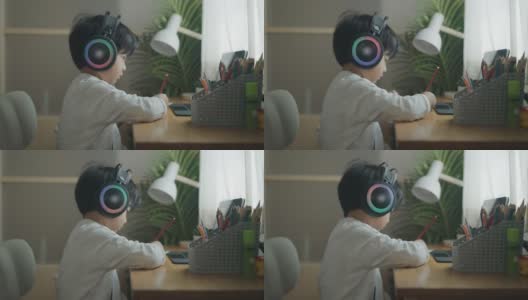 一个戴着耳机在家学习的男孩高清在线视频素材下载