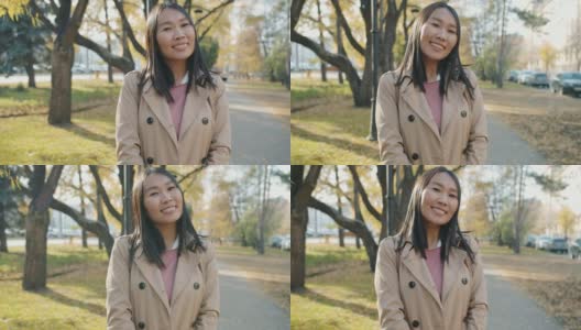 成功的亚洲女学生站在户外微笑看着相机的肖像高清在线视频素材下载