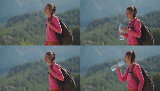 在阳光明媚的日子里，一名女子徒步旅行时口渴了，用塑料瓶喝水高清在线视频素材下载