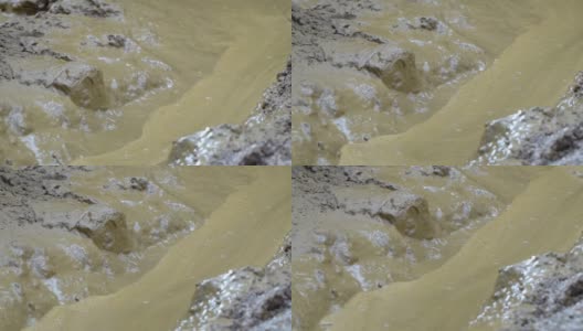 在洪水泛滥和春季大雨期间，肮脏的河水和淤泥的特写高清在线视频素材下载