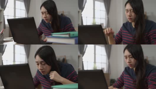 一位台湾女大学生在家里学习时，眼睛突然变得模糊，她靠在笔记本电脑屏幕前，试图看得更清楚高清在线视频素材下载