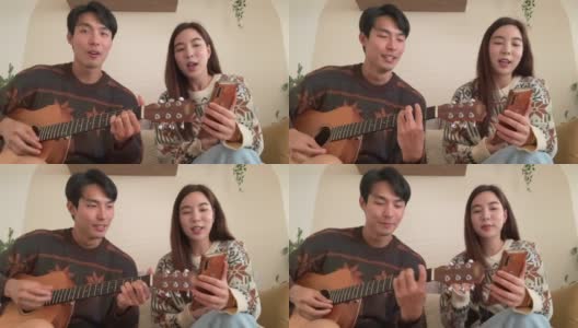 年轻夫妇在客厅里一起唱歌玩得很开心高清在线视频素材下载