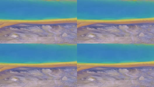 无人机视图彩虹湖边缘与梯度彩色海岸线，流光黄色温跃层细菌，清澈的蓝色水陆地外观。高清在线视频素材下载